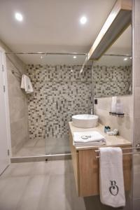 a bathroom with a sink and a shower at Baron Boutique Hotel Yerevan in Yerevan