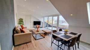 sala de estar con sofá y mesa en Lovely 2-bedroom loft with panoramic view., en Kristiansund