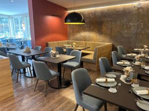 a restaurant dining room with tables and chairs at Hotel Stempferhof in Gößweinstein