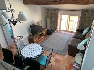 a living room with a couch and a table at Loft 3 pièces dans vieil Antibes in Antibes