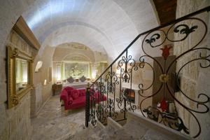a staircase with a red couch in a room at Arte Cave Hotel in Urgup