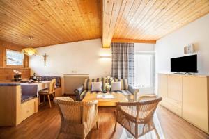 a living room with a table and a dining room at Residence Pichler Apartment 4 in San Leonardo in Passiria