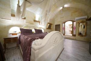 a bedroom with a large white bed in a room at Arte Cave Hotel in Urgup