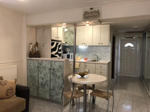 a kitchen and a table and chairs in a room at VILLA ELENA 5***** in Vromerí