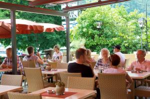 a group of people sitting at tables in a restaurant at Hotel Vier Löwen in Traben-Trarbach