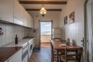 a kitchen with a table and a counter top at La Zia Marisa in Montepulciano