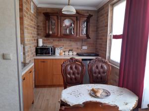 a small kitchen with a table and two chairs and a table and a table at Apartament Jasiu in Ustka