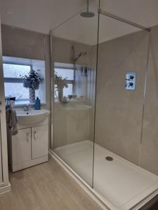 a bathroom with a shower and a sink at St Leonards Guest House in Largs