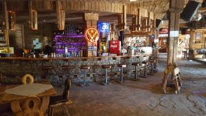 a bar with a bunch of bar stools in a room at Na planina in Razlog