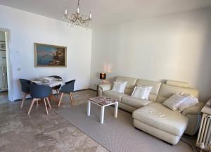 a living room with a couch and a table at Lago Maggiore- Casa Roccia-Ferienwohnung in Pino sulla Sponda in Pino Lago Maggiore