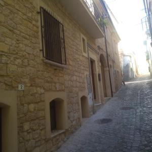 a stone building with a window on a street at Creta Rossa in Larino