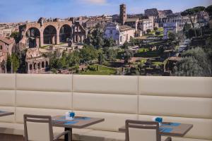 a view of the city from a restaurant with tables and chairs at Occidental Aurelia in Rome