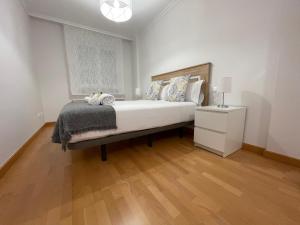 A bed or beds in a room at OKTHEWAY Castelao Street
