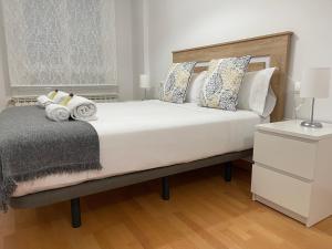 A bed or beds in a room at OKTHEWAY Castelao Street