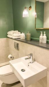 a bathroom with a white sink and a toilet at The Swan Hotel and Spa in Newby Bridge