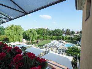 a view of a pool from a balcony with flowers at Hotel Villa Costanza in Pontenure