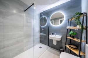 La salle de bains est pourvue d'un lavabo et d'un miroir. dans l'établissement City Centre Pool & Parking, à Malaga