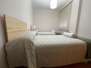 A bed or beds in a room at OKTHEWAY Castelao Street