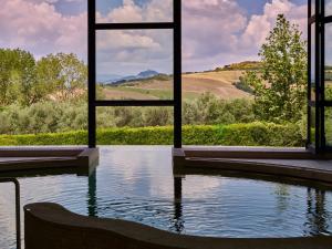 a large pool of water in front of a building at Fonteverde Lifestyle & Thermal Retreat - The Leading Hotels of the World in San Casciano dei Bagni
