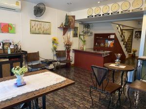 a restaurant with tables and chairs in a room at Jane's House in Chiang Mai