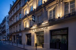 a building with a sign on the side of a street at Hôtel Hélios Opéra in Paris +68 photos