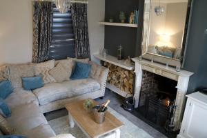 a living room with a couch and a fireplace at Stunning 5 Bedroom Victorian home with optional hot tub in Pershore