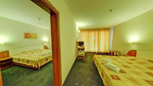 A bed or beds in a room at Hotel Exotica