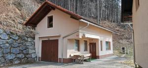 a small house with a bench next to a wall at Apartma Regina in Slovenj Gradec