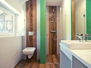 a bathroom with a toilet and a sink at Hotel Podjadek in Górzno