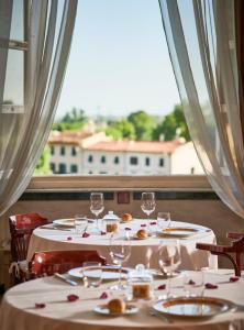 a dining room table with two chairs and a table cloth at Bagni Di Pisa Palace & Thermal Spa - The Leading Hotels of the World in San Giuliano Terme