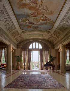 a large room with a ceiling with a painting at Bagni Di Pisa Palace & Thermal Spa - The Leading Hotels of the World in San Giuliano Terme