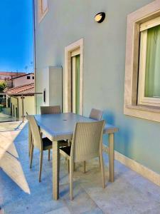 a blue table and chairs on a patio at Appartamento Iris in San Vincenzo +6 photos