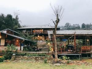 a large house with a tree in front of it at Deja Vu Sapa Homestay in Sapa