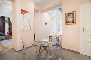 a dining room with a glass table and chairs at BpR Adagio Design Home with A/C in Budapest