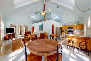 a kitchen and living room with a wooden table and chairs at The Lemonade Stand in West Tisbury