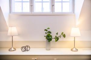 two lamps on a shelf with a vase with a plant at Kings Garden Penthouse - 4BR & 2Bath - by Daniel&Jacob's in Copenhagen +20 photos