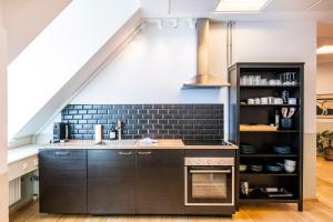 a kitchen with a sink and a stove at Kings Garden 1 by Daniel&jacob's in Copenhagen