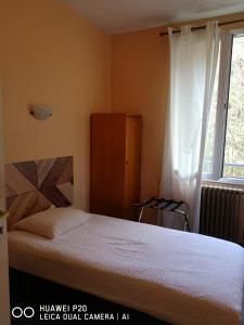 a bedroom with a bed and a window at Hôtel Le Memphis in Poitiers +18 photos