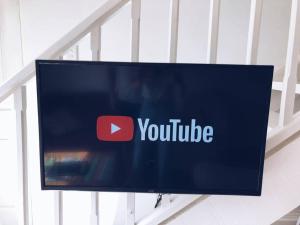 a television screen with the youtube logo on it at Grace by the Sea in East London