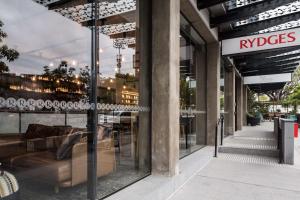 a store front with chairs and tables in front of it at Rydges Fortitude Valley in Brisbane