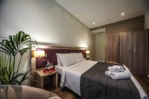 a hotel room with a bed with towels on it at Hotel Zara Milano in Milan