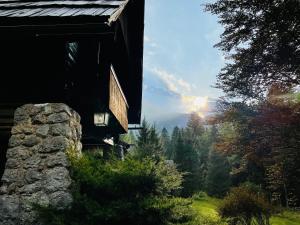 a view from the outside of a cabin with a view of the forest at Red Beech Cabin at Lake Bohinj & Triglav National Park in Bohinj