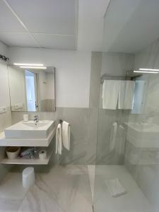 biała łazienka z umywalką i prysznicem w obiekcie Apartamento “El Lometico” w mieście Carboneras