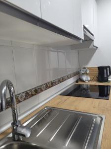 a kitchen with a sink and a counter at Disfruta De Playa Y Ciudad in Valencia