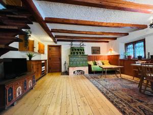 a living room with a fireplace and a table at Red Beech Cabin - An Alpine Cabin near Lake Bohinj in Bohinj