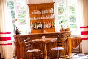 a bar with two chairs and a table in a room at La Ramade - Teritoria in Avranches