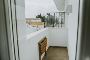 a stairway with a white wall and a stair railing at Apartamentos ZHR 2 in Zahara de los Atunes