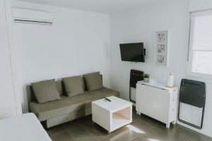 a living room with a couch and a tv at Apartamentos ZHR 2 in Zahara de los Atunes
