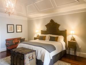a hotel room with a bed and a dresser at The Twelve Oaks Bed & Breakfast in Covington