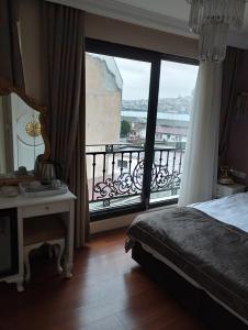 a bedroom with a bed and a large window at Gulhane Garden Hotel in Istanbul